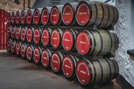 Bushmills, Northern Ireland, Aug 2019 Rows of large wooden barrels with maturing single melt...