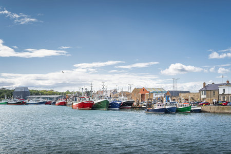 Several colourful fishing boats moored in Howth harbour. Phishing and shellfish fishing equipment on...