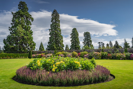 Circular flowerbed in beautiful Powerscourt garden with hedges, decorative trees, fountains and forest, Enniskerry, Wicklow, Irelandの写真素材