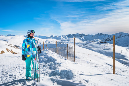 Portrait of a woman skier looking at distant slopes on the top of the snowy Pyrenees Mountains. Winter ski holidays in El Tarter, Grandvalira, Andorraの写真素材