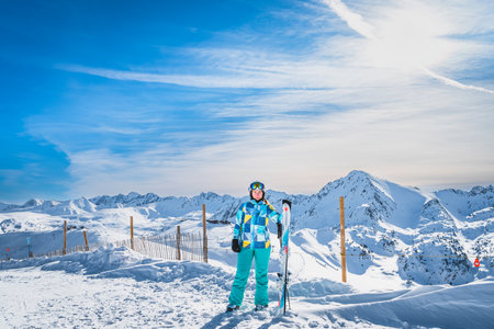 Portrait of a woman skier looking at camera on the top of the snowy Pyrenees Mountains. Winter ski holidays in El Tarter, Grandvalira, Andorraの写真素材