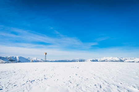 Single radio tower with two satellite dishes on the top of a snowy mountain peak at winter, Andorra, El Tarter, Pyrenees Mountains, Grandvaliraの写真素材