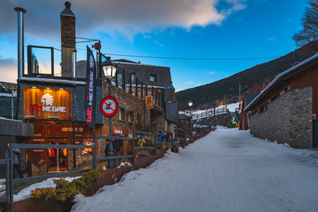 El Tarter, Andorra, Jan 2020 Street lights illuminating shops, bars, restaurants and residential buildings. Ski winter holidays, Pyrenees Mountainsのeditorial素材