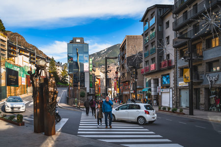 Andorra la Vella, Andorra, Jan 2020 People walking on, narrow streets with modern shops, restaurants and sculptures in capital city, Pyrenees Mountainのeditorial素材