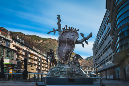 Andorra la Vella, Jan 2020 Noblesa del temps, Nobility of time, sculpture by Salvador Dali, melting clock and angels. Long exposure, stretched cloudsのeditorial素材