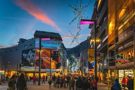 Andorra la Vella, Jan 2020 Crowd of people duty free shopping, street with modern shops and mall at night, illuminated by street lights, Pyreneesのeditorial素材