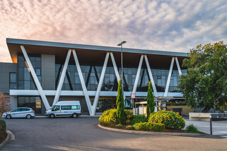 Perpignan, France, Jan Building, exterior of Perpignan Rivesaltes Mediterranean airport with decorative trees and bushes at dramatic sunriseのeditorial素材