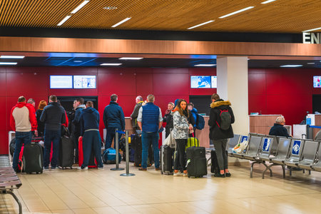 Perpignan, France, Jan 2020 People, tourists standing with luggage in a queue for check in and flight departure, Mediterranean airportのeditorial素材