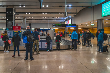 Dublin, Ireland, Feb 2020 People, families waiting at belt conveyor to collect luggage after arrival to Dublin airportのeditorial素材