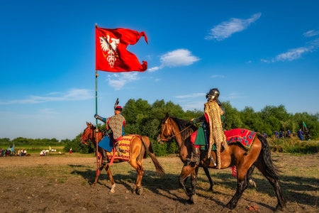 Gniew, Poland, Aug 2020 Polish hors cavalry, Hussars, riding with the flag, historical reenactment of Battle of Gniewのeditorial素材