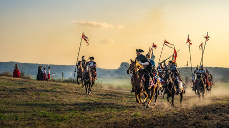 Gniew, Poland, Aug 2020 Charge of the Hussars, polish heavy cavalry, at sunset, historical reenactment of Battle of Gniewのeditorial素材