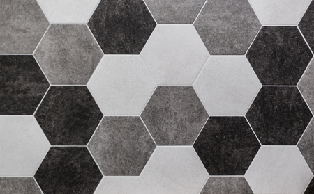 large hexagonal background. Concrete structure, shades of gray. Close-up of hexagon tiles in kitchen.の写真素材