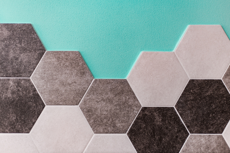 large hexagonal background. Concrete structure, shades of gray. Close-up of hexagon tiles in kitchen.の写真素材