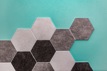 large hexagonal background. Concrete structure, shades of gray. Close-up of hexagon tiles in kitchen.の写真素材