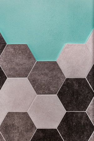 large hexagonal background. Concrete structure, shades of gray. Close-up of hexagon tiles in kitchen.の写真素材