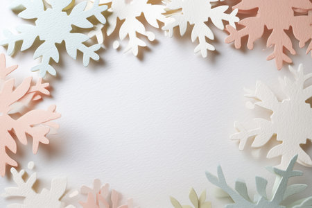 Elegant pastel paper snowflakes frame on textured white background with ample copy space for winter and holiday design.の素材