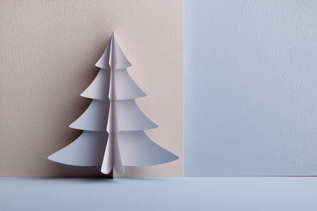 Elegant white paper Christmas tree in a minimalist setting with soft pastel color blocks.の素材