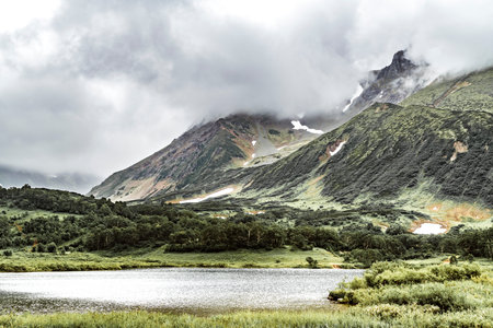 Volcanic landscape with mountains and lake on Kamchatka peninsula, Russia
