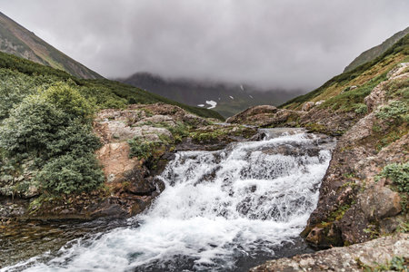 Mountain landscape of Kamchatka: beautiful waterfall.