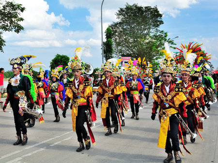 Tenggarong, Indonesia - October 27th, 2012: carnival with unique costumes on public roads within...