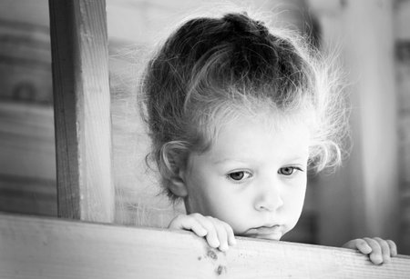 Little sad girl on the playground. Black and white series.の写真素材