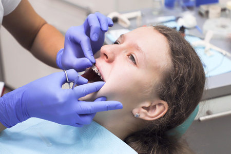 Teenage girl at a dentists reception. Dental treatment, bracesの写真素材