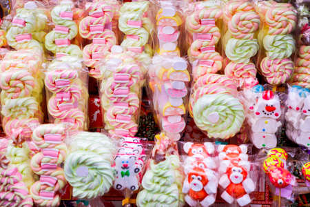 Candy on a stick, standing in a row. Aerial marshmallows, close up.の写真素材