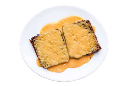 Disgusting sandwiches lying on a white plate. Unhealthy breakfast. Isolated on the white background.の写真素材