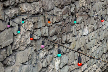 Stone wall texture with multicolored lanterns.の写真素材