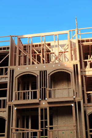 the construction of a new wooden house on blue sky background
