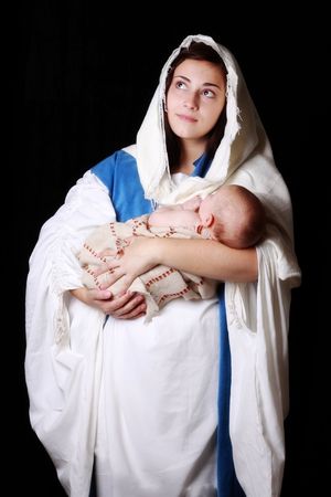 Mary holding baby Jesus and gazing toward Heavenの写真素材