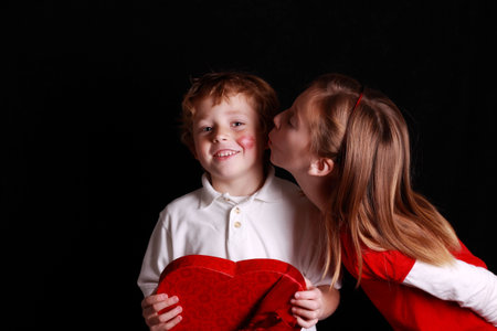 little Valentine boy getting his first kissの写真素材