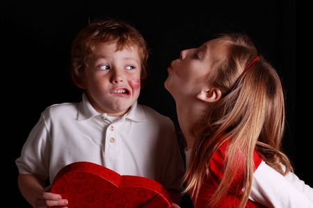 little boy disgusted by incoming valentine kissの写真素材