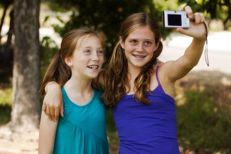 happy young girls posing for a pictureの写真素材