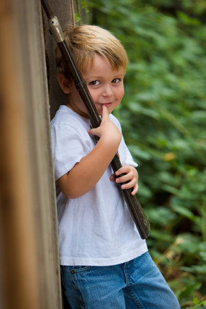 Happy child with toy rifle