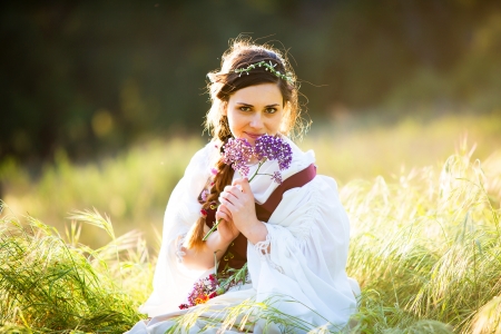 Beautiful old fashioned girl with flowersの写真素材
