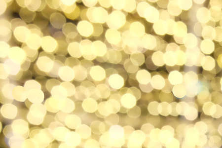 golden abstract bokeh lights. Christmas holiday lights bokeh backgroundの写真素材