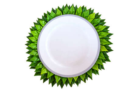 White plate with banana leaf folds around the edgeの写真素材