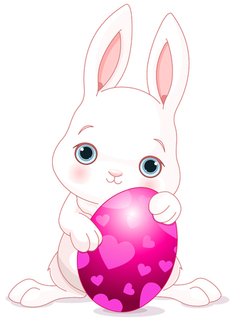 A cute Easter bunny standing near brightly colored eggのイラスト素材
