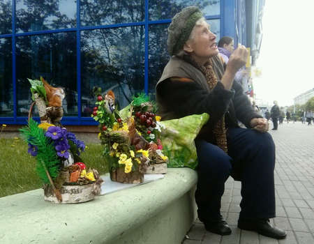An old woman sell folk art goods at the street. Minsk, Belarus. 2014, 11 of May.の素材
