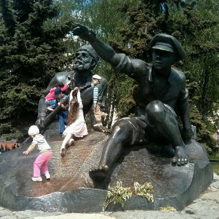 Minsk, Belarus. 2014, 11 of May. Children play near monument.の素材