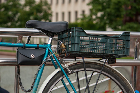 the view of a bicycle chained at close range, the trunk, the saddle
