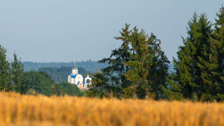 White Orthodox Church in the countryside. Panoramic view. Belarus, Minsk region, Yuzufovo.の写真素材