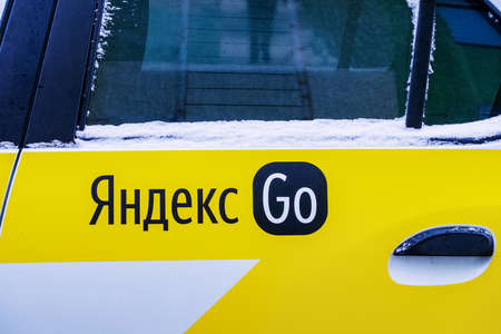 Minsk, Belarus - January 29, 2022: The logo of the Yandex.Go (Russian: Yandex.Go) application on the cab car door is an international company that operates a cab aggregation business in Russia, the CIS, Eastern Europe, Africa and the Middle East.のeditorial素材