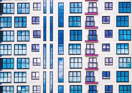 A brightly colored facade of a residential building. Abstract background of colored windows.の写真素材