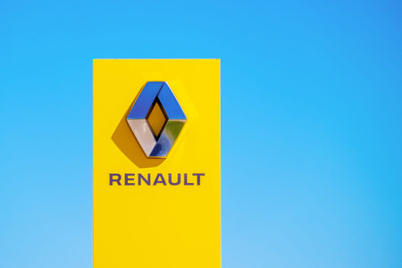Renault. A red billboard with the Renault logo on a blue sky background.