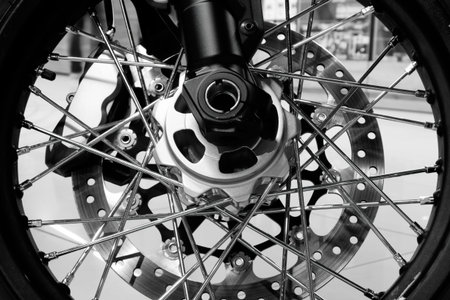 Bike. Wheel close-up. Spokes, rim, brake pads and disc. Monochrome image