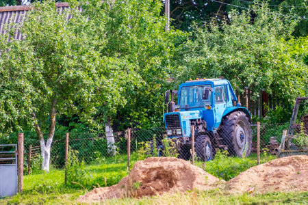 Minsk region, Belarus - July 10, 2022: Belarus tractor in a farmer's gardenのeditorial素材