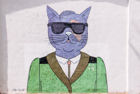 Minsk, Belarus - July 15, 2018: PURPLE by Mitya Pisliak. A purple cat in sunglasses and a green jacket. Street art. Mural in Minsk (Belarus). Dolgobrodskaja st.12. 2016 yearのeditorial素材