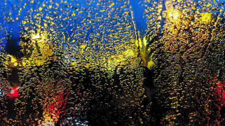 Color abstraction. Blurred focus. View through frosted glass of the lights of the city at night